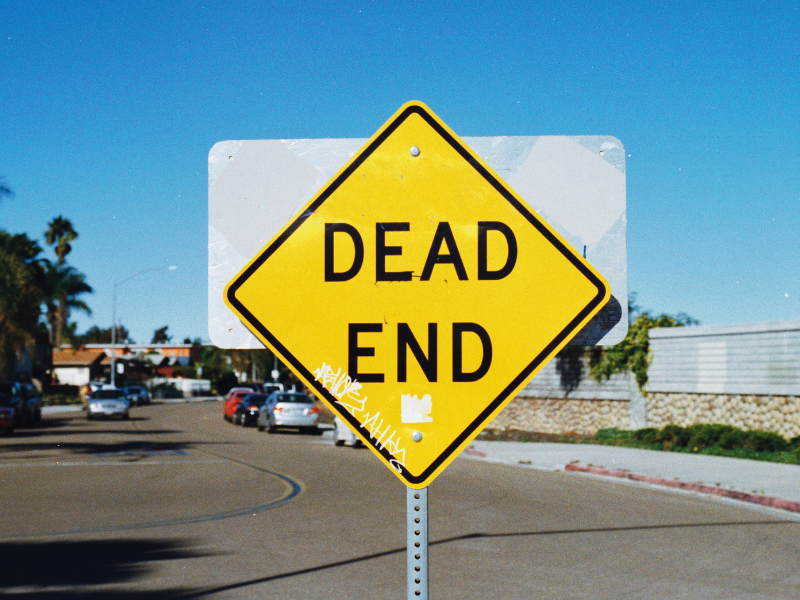 Dead end road sign with blue sky
