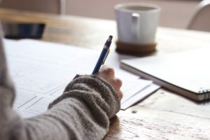 woman writing CV at desk