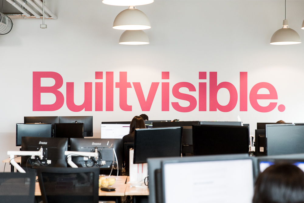 photo of Builtvisible's office with their logo on the wall