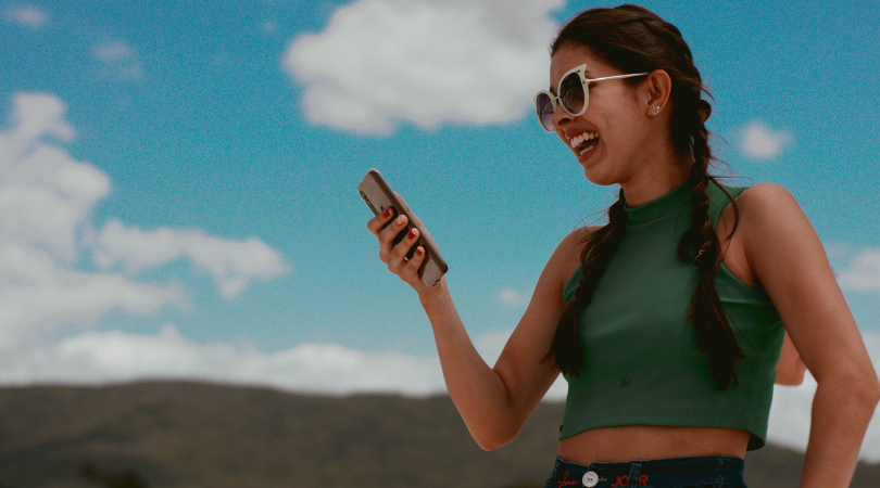 Girl looking at phone smiling 