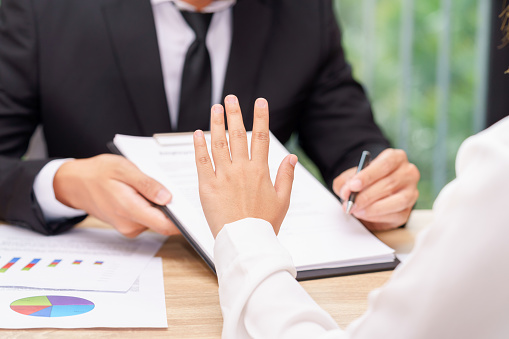 Customer or woman says no or hold on when businessman giving pen for signing a contract.