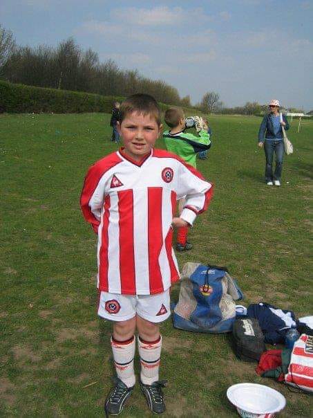 A childhood photo of Declan Reilly playing football 